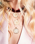 Gold coin pendants layered on model