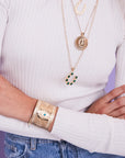 Model wearing gold horseshoe cuff
