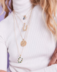 Gold layered lucky pendants on model