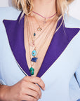 Gold layered pendants on model