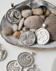 Stylized silver coins with seashells