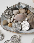 Silver coins stylized with seashells