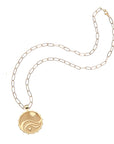 Gold love, courage, and strength coin on drawn link chain