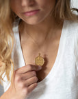 Model wearing gold original Aquarius coin pendant
