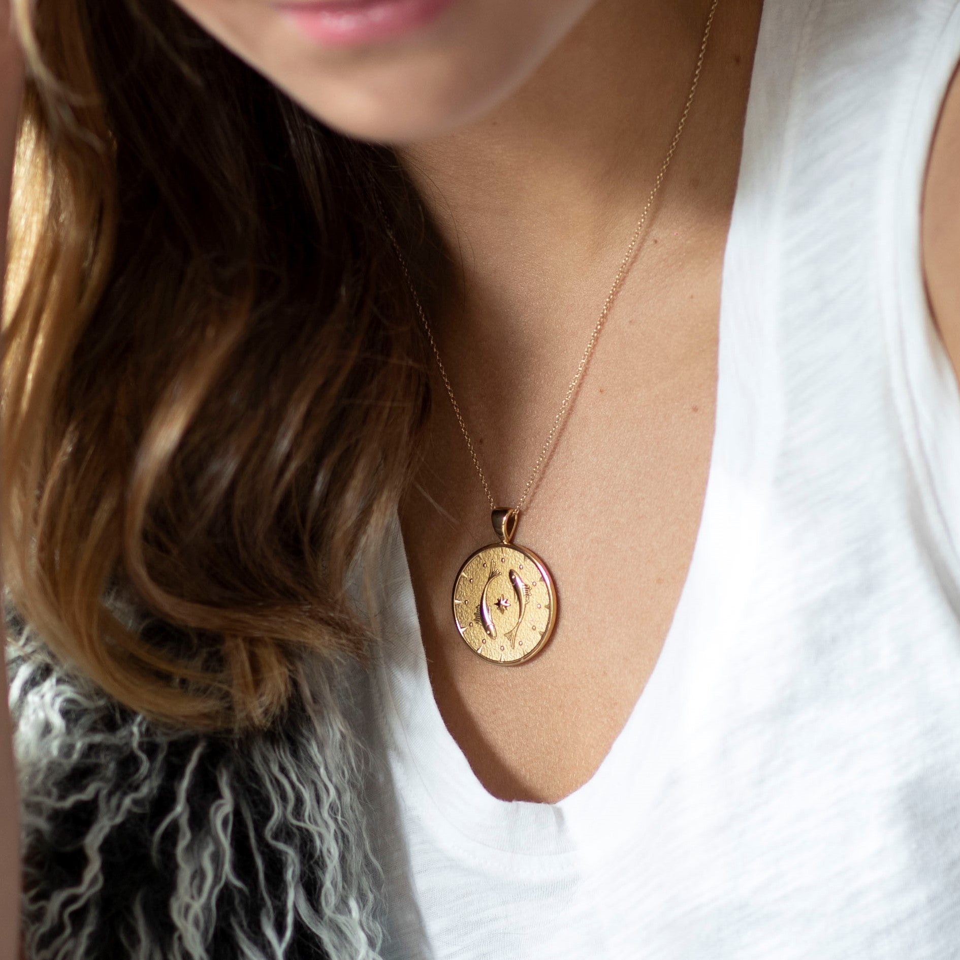Model wearing gold original Pisces coin pendant