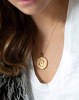 Model wearing gold original Pisces coin pendant