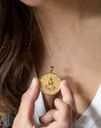 Model wearing gold original Pisces coin pendant