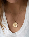 Model wearing gold original Taurus coin pendant