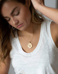 Model wearing gold original Cancer coin pendant