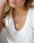 Model wearing gold original Leo pendant
