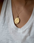 Model wearing gold original Leo pendant