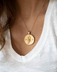 Model wearing gold original Scorpio coin pendant