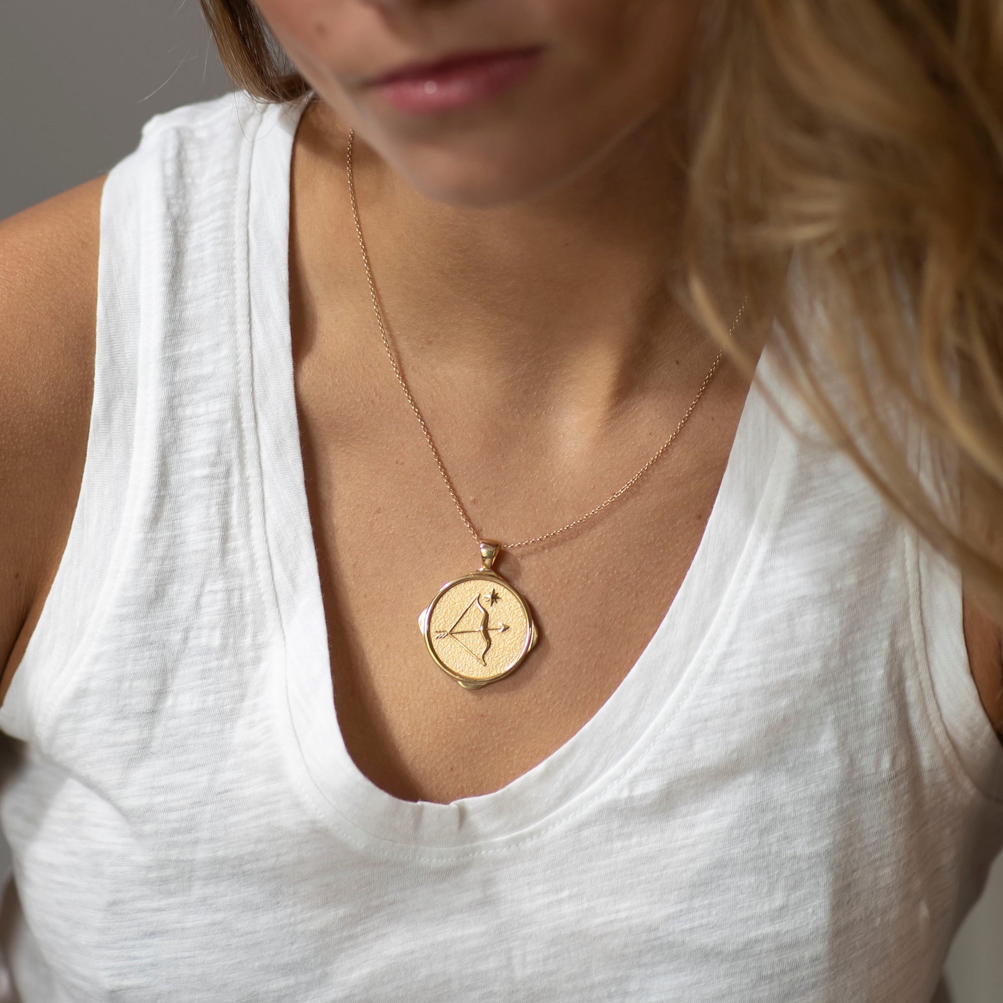 Model wearing gold original Sagittarius coin pendant