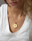 Model wearing gold original Sagittarius coin pendant