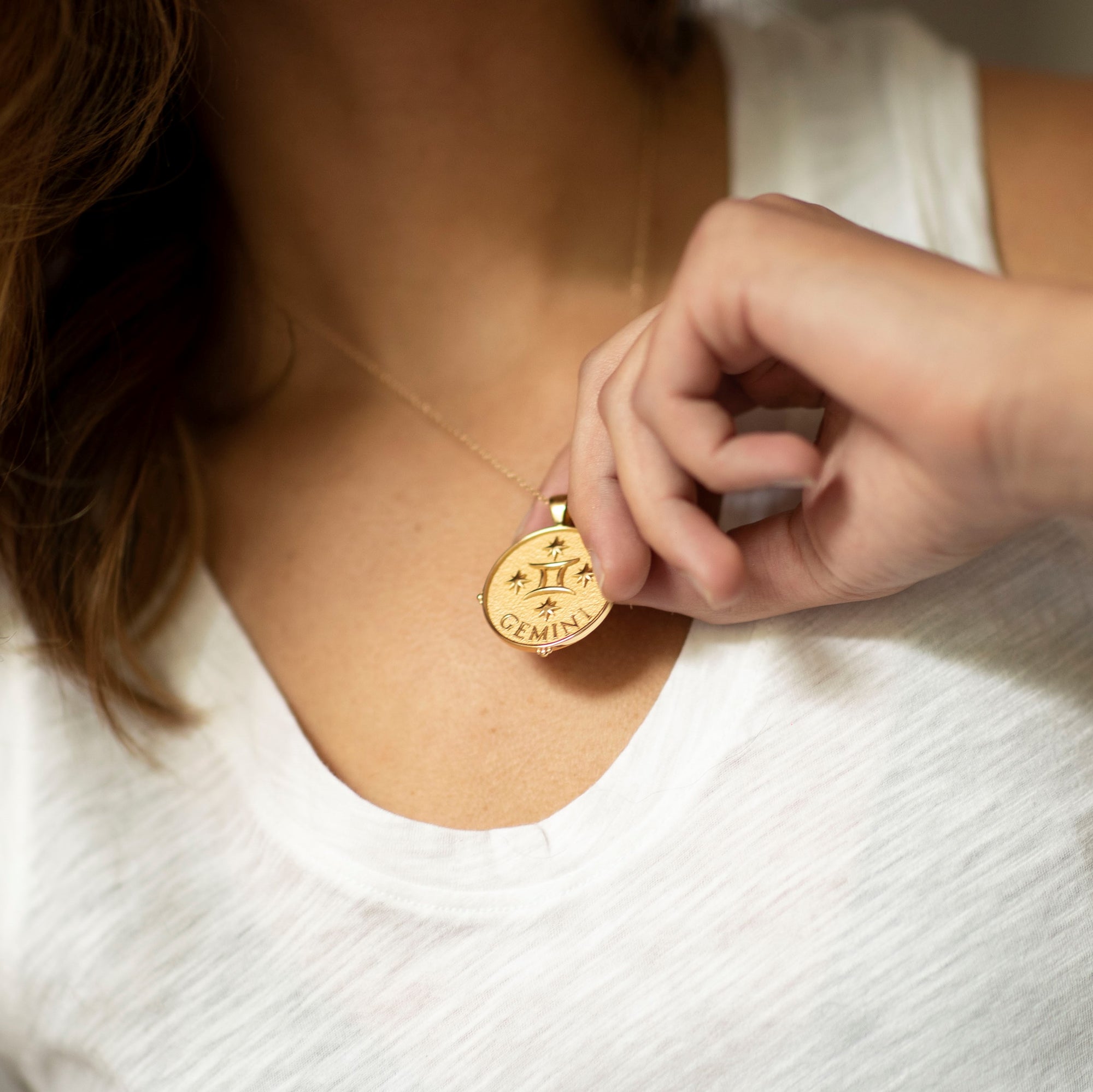 Model wearing gold original Gemini pendant