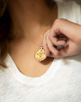 Model wearing gold original Gemini pendant