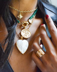 Gold layered necklaces on model