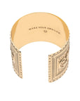 Gold horseshoe cuff says "Make your own luck" inside