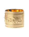 Side view of gold horseshoe cuff shows flower design