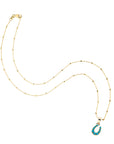 Gold horseshoe pendant on 14 karat satellite chain