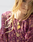 Gold layered necklaces on model