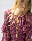 Layered coin pendants on model