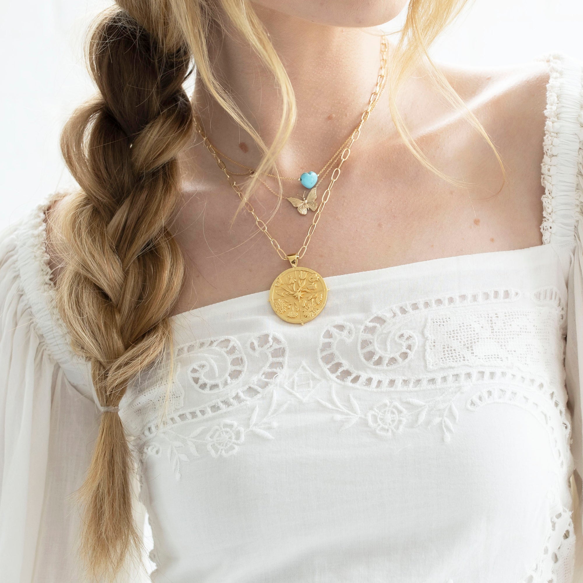 Gold necklaces layered on model