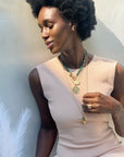 Model wearing gold layered necklaces