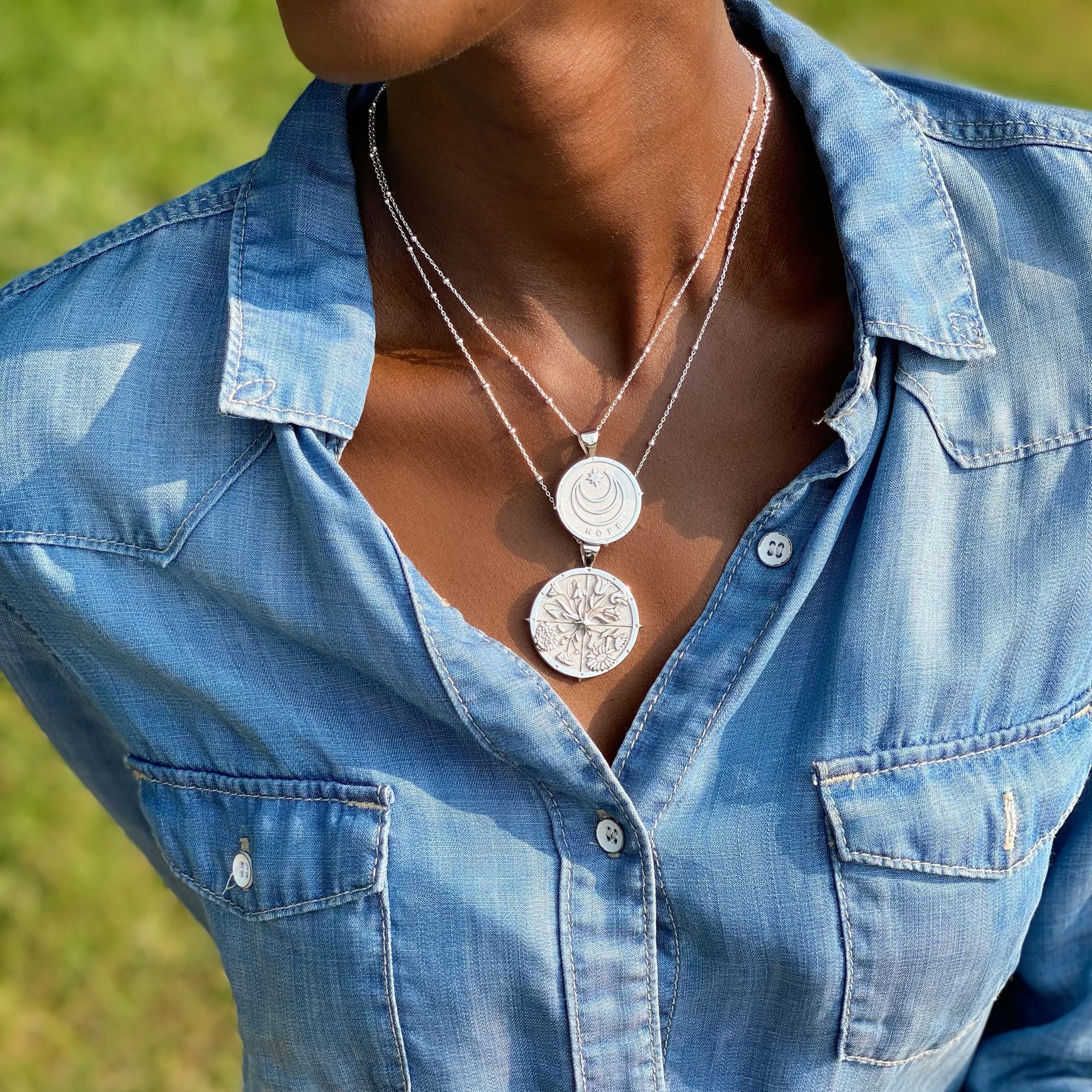Model wearing layered silver coins
