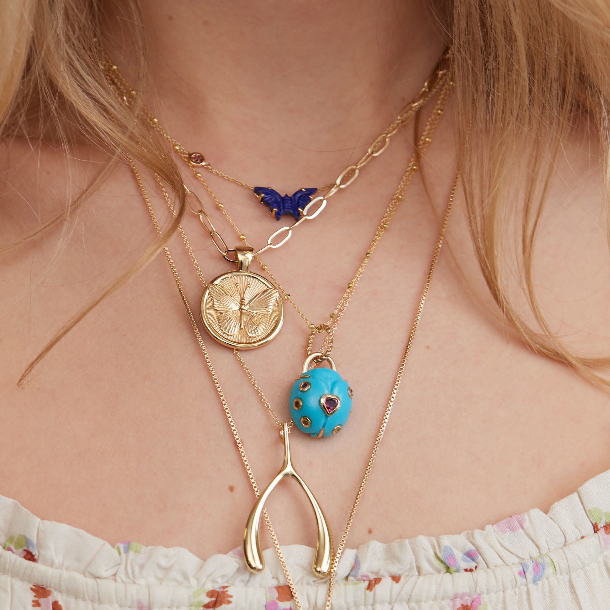 Gold layered necklaces on model