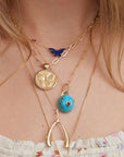 Gold layered necklaces on model