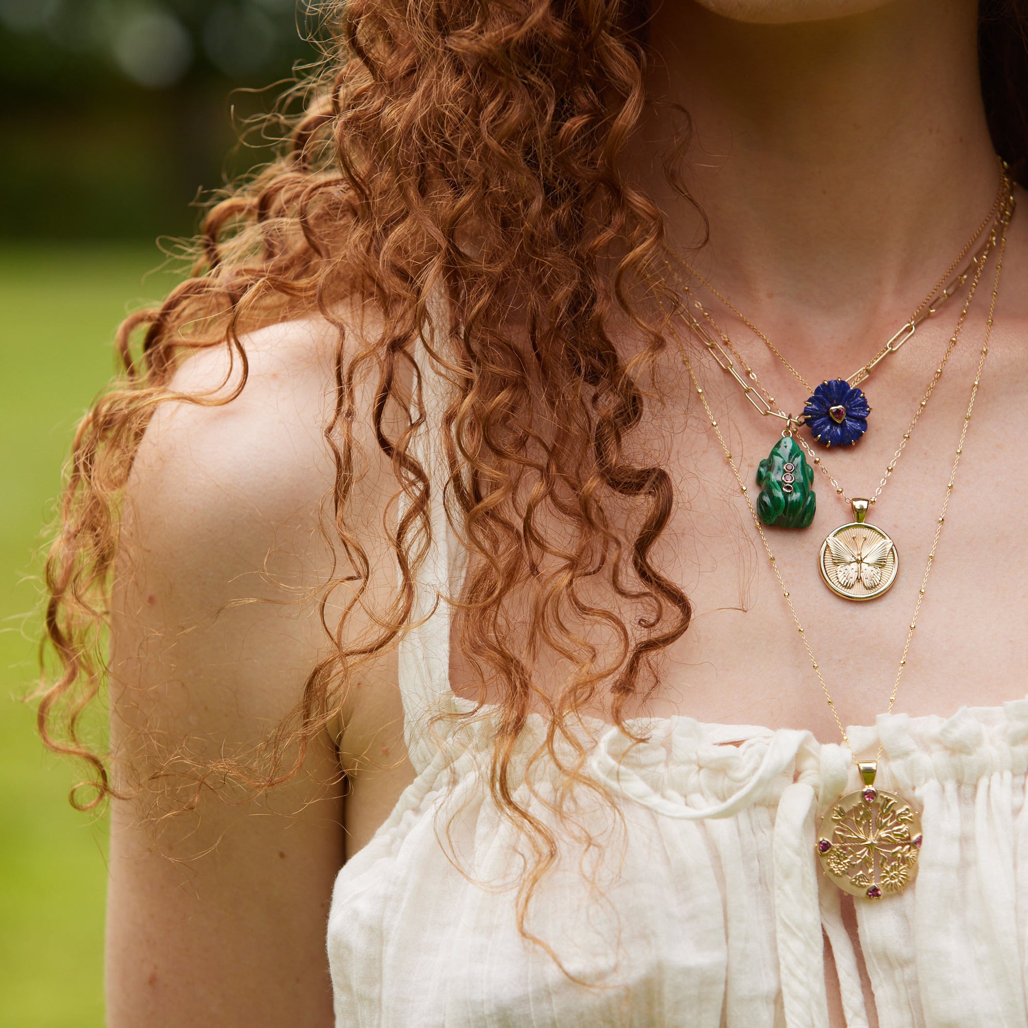 Gold layered necklaces on model