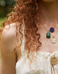 Gold layered necklaces on model