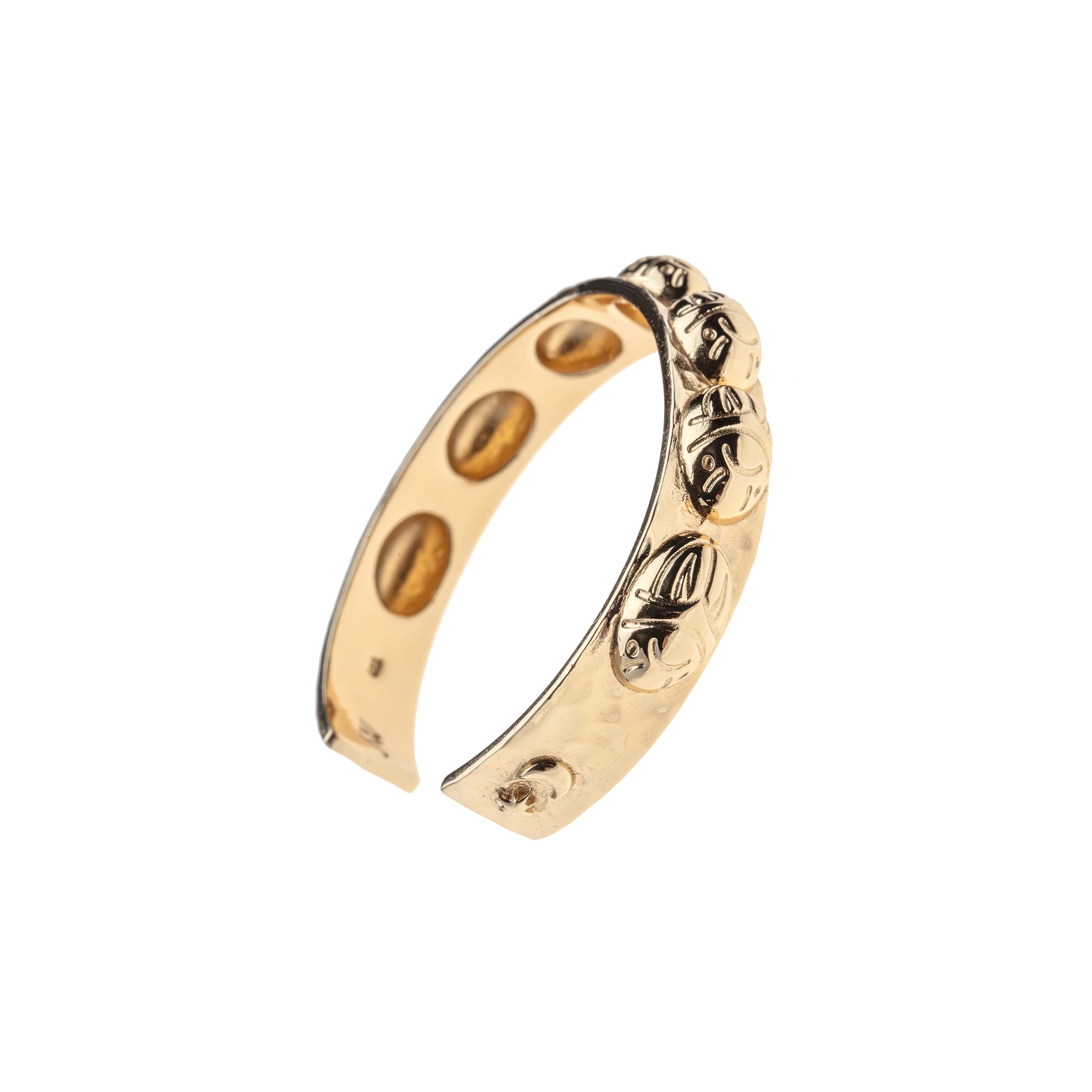 Side view of gold cuff with repeating scarab design