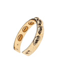 Side view of gold cuff with repeating scarab design