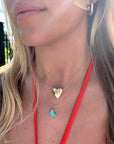 Model wearing gold heart pendant on satellite chain