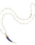 Carved lapis tusk on 14 karat satellite chain