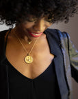 Model wearing gold original Cancer coin pendant