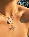 Gold dragonfly pendant on model