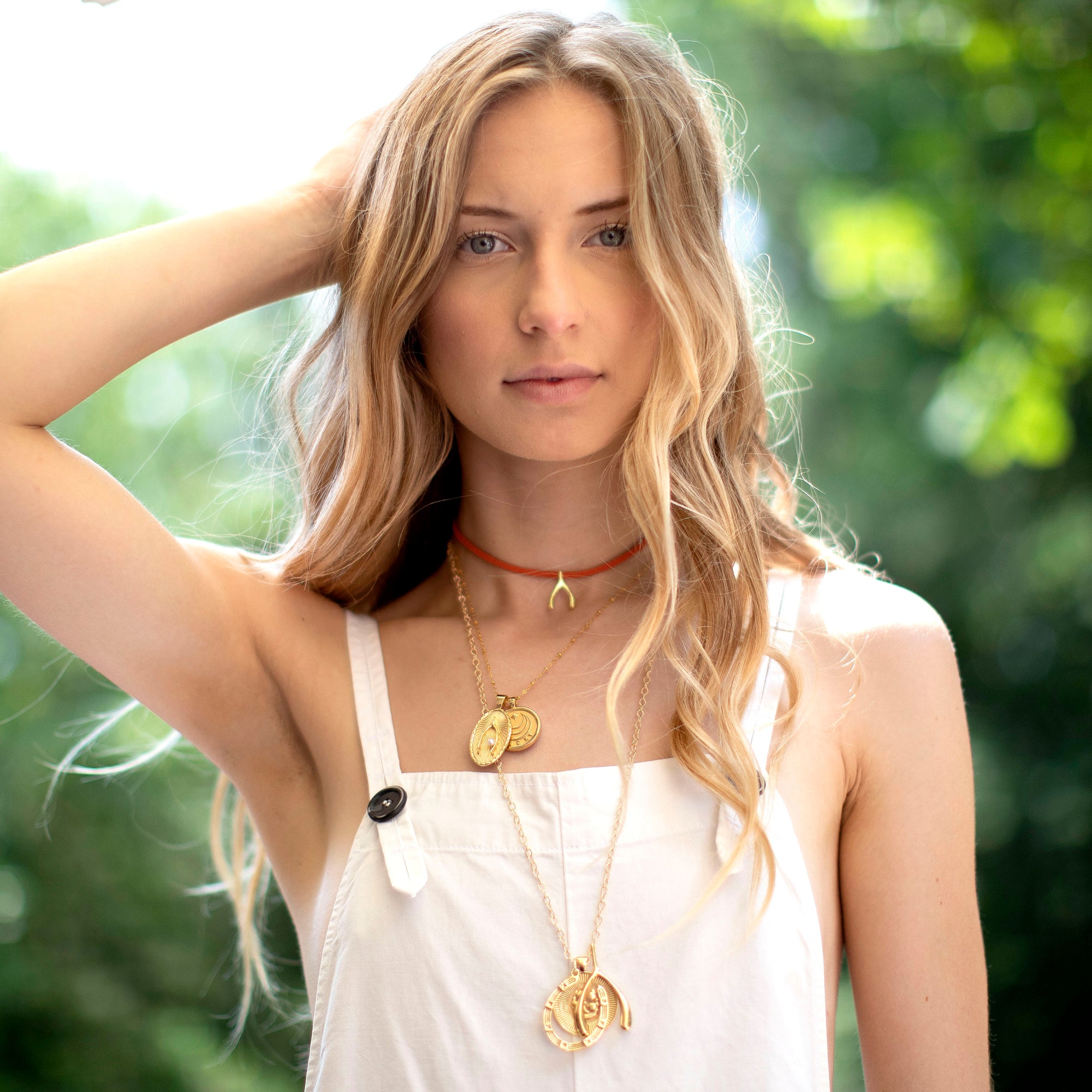 Gold layered necklaces on model