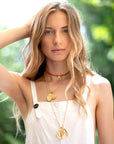 Gold layered necklaces on model