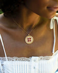 Model wearing gold lucky coin pendant