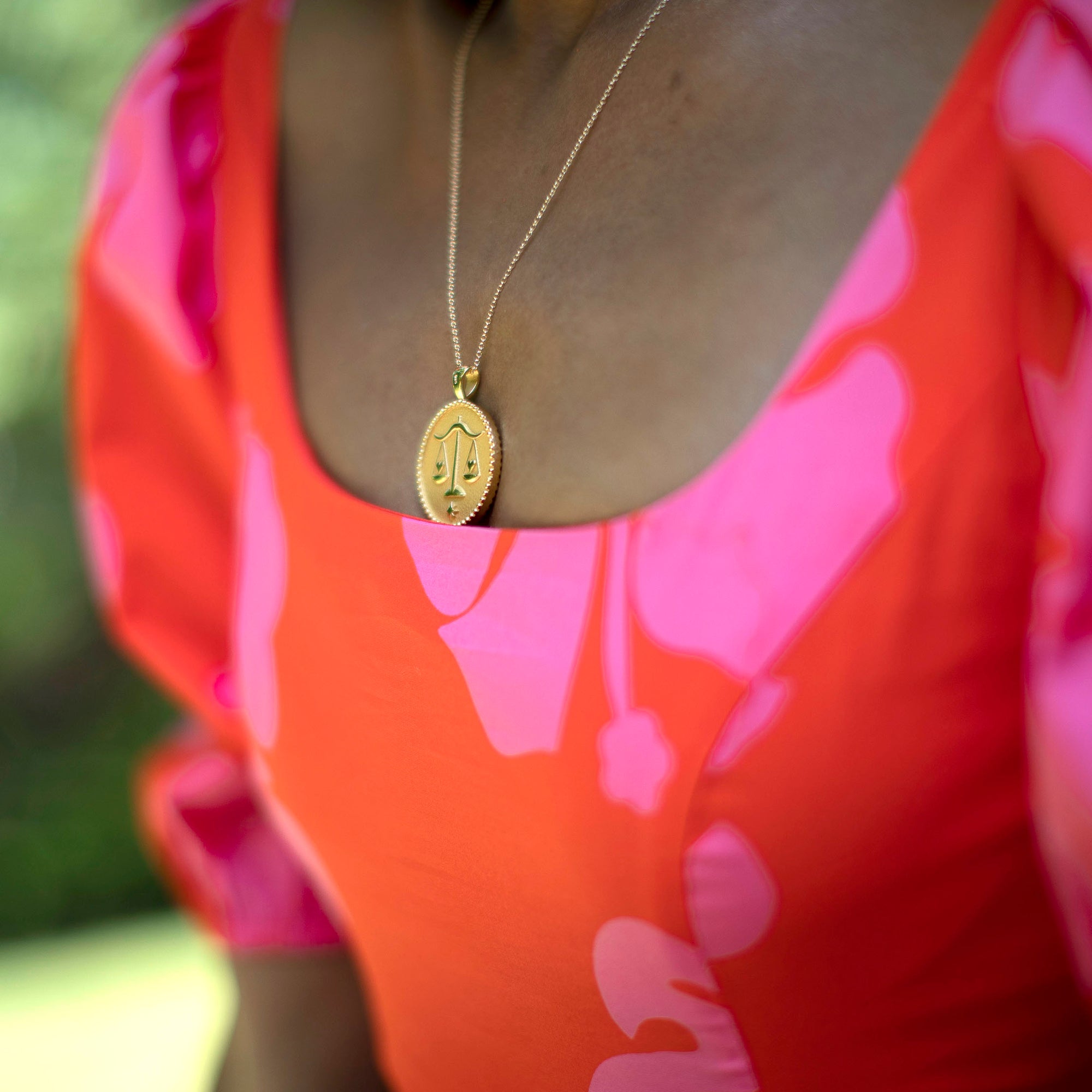 Model wearing gold original Libra coin pendant