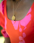 Model wearing gold original Libra coin pendant
