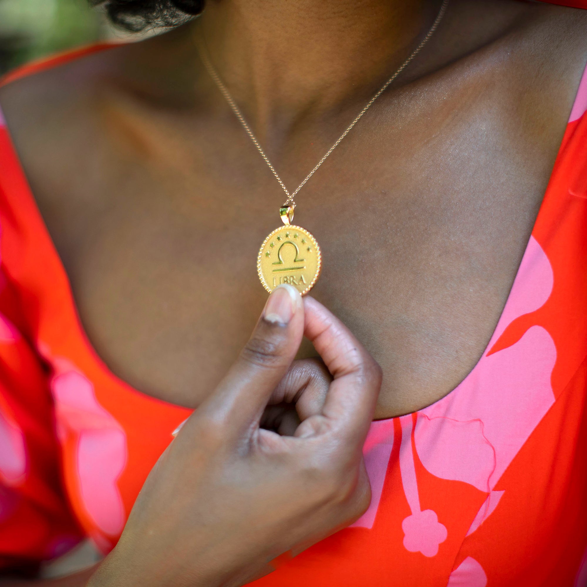 Model wearing gold original Libra coin pendant