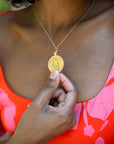 Model wearing gold original Libra coin pendant