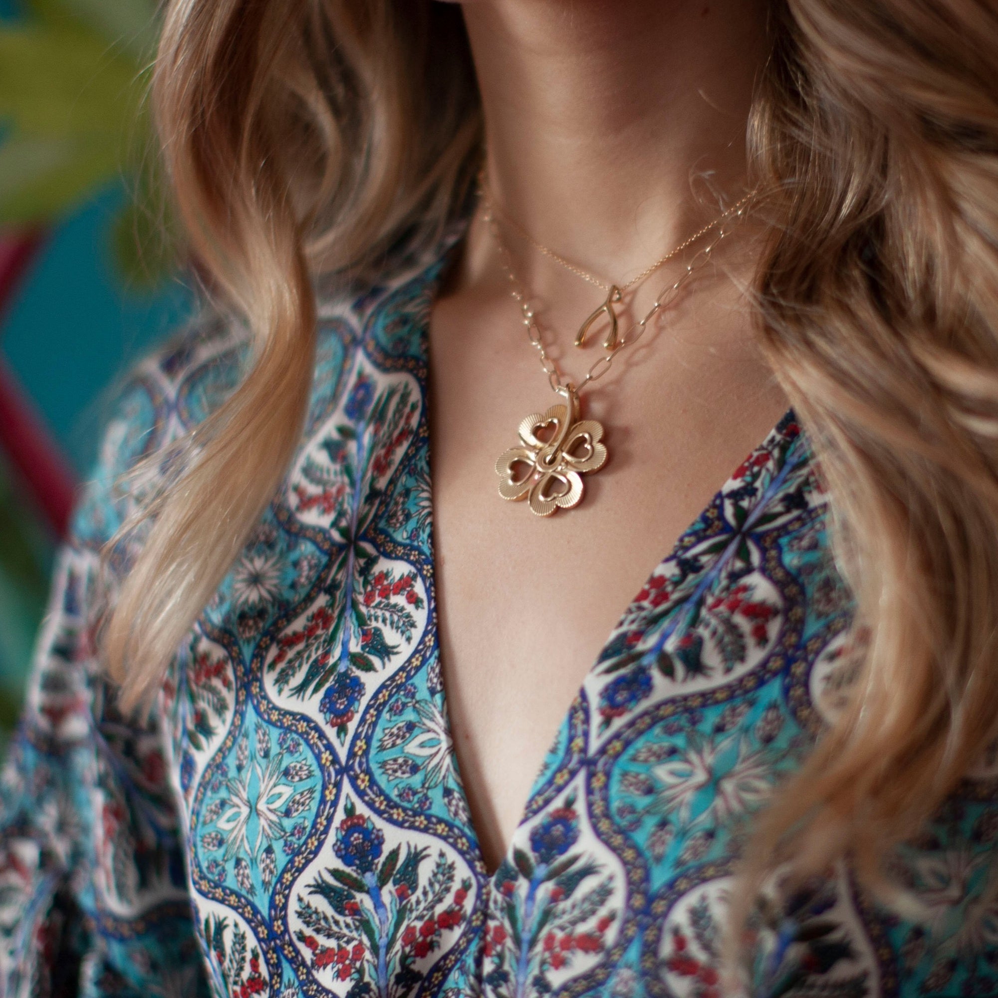 Gold layered necklaces on model