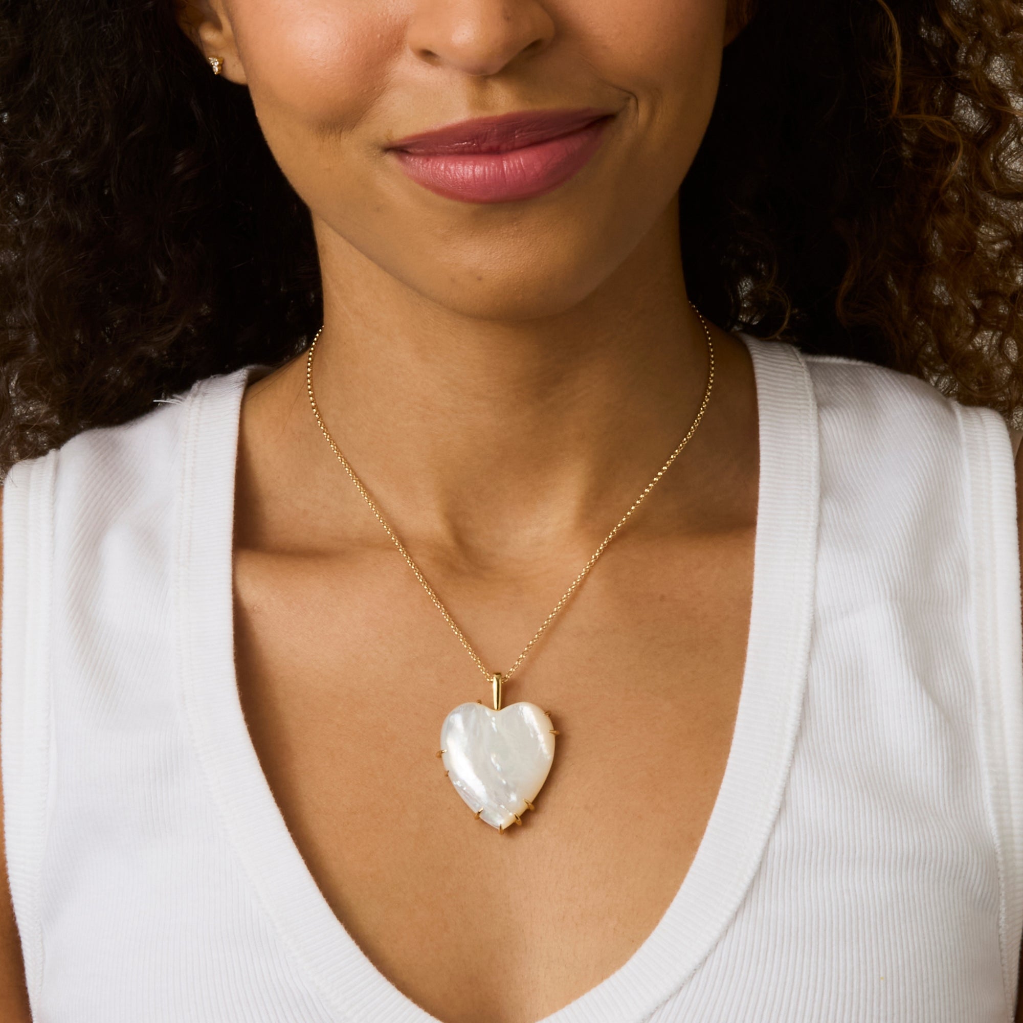 Model wearing white heart pendant necklace