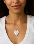 Model wearing white heart pendant necklace