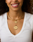 Model wearing the gratitude tile coin pendant on the classic rolo and the gratitude olive pendant on the gold neck cuff